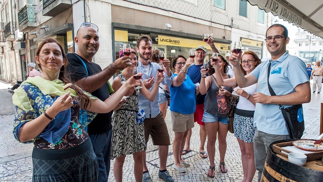 Group enjoying wine tasting on a Lisbon food and wine walking tour.