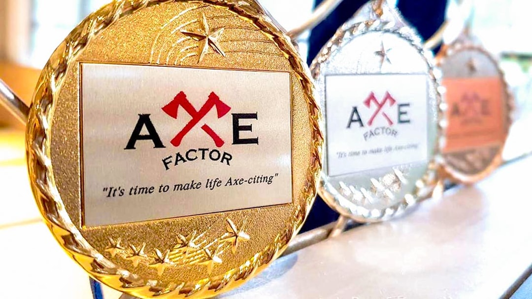 Axe Factor medals displayed in Sentosa, featuring the slogan "It's time to make life Axe-citing.