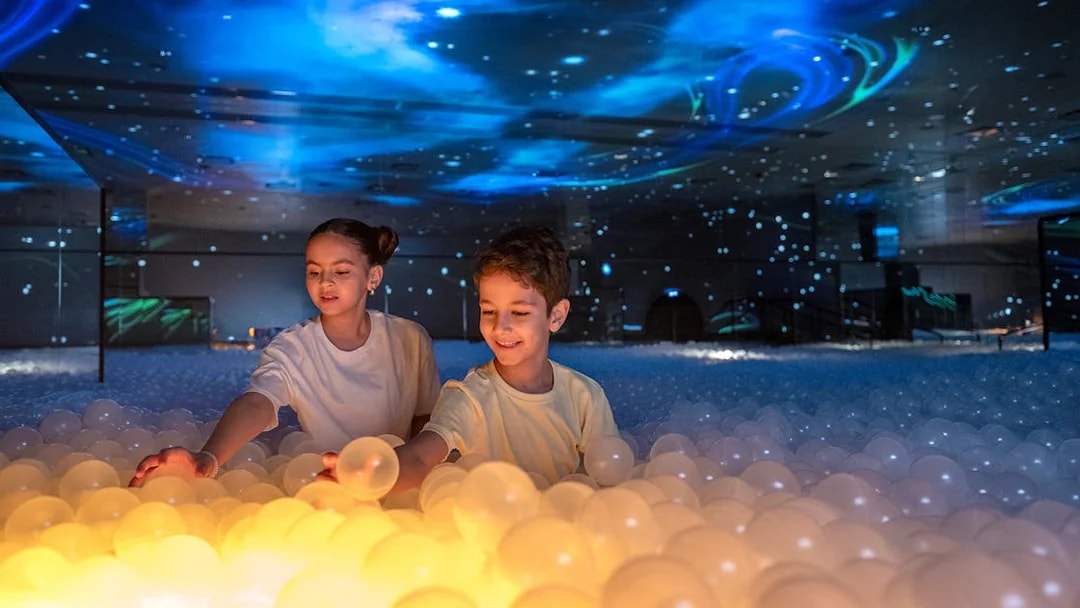 Children playing with glowing balls at Celestia inside AYA Universe.