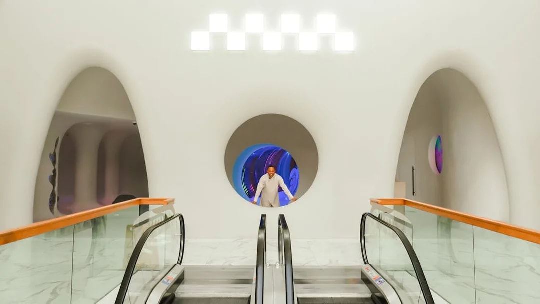 Man standing at entrance of AYA Universe in Dubai's WAFI City Mall.