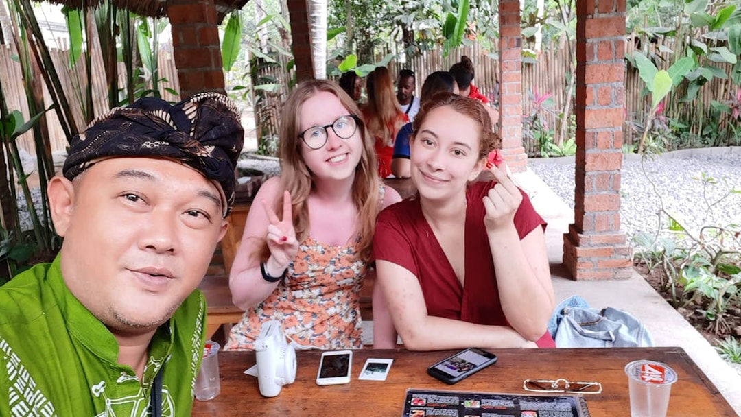 Group enjoying a meal at a Bali restaurant during a private car tour.