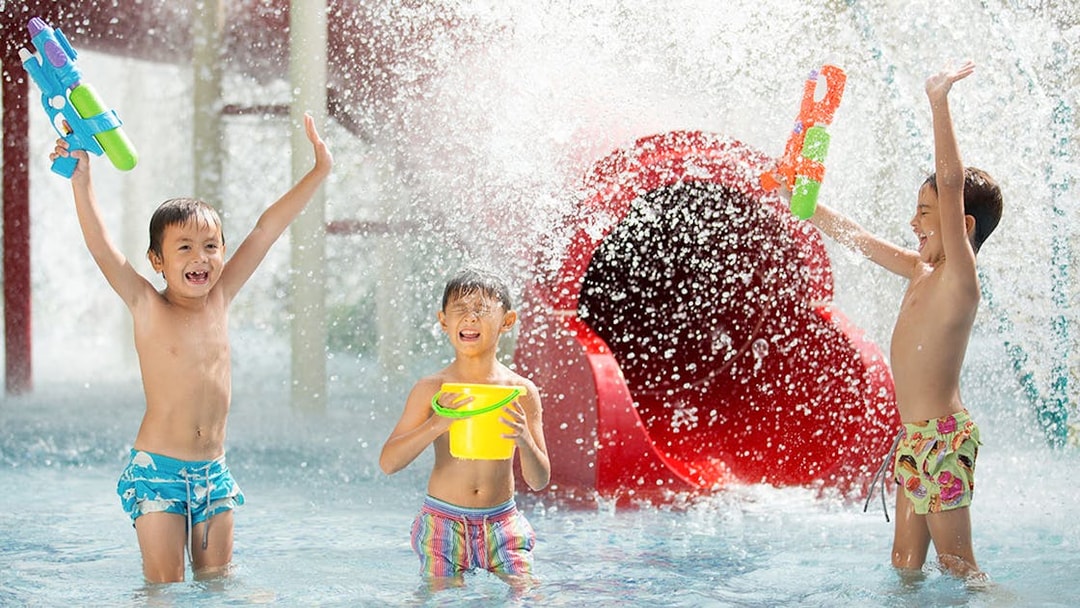 Children playing with water guns at Jungle Splash water park.