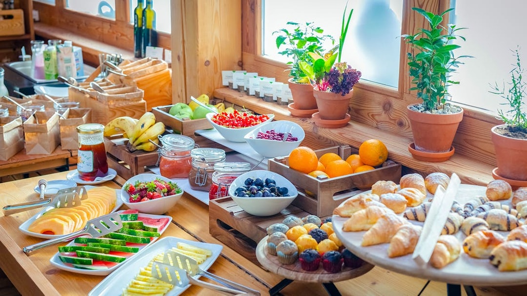 Breakfast buffet with tropical fruits and pastries at Bali Zoo, Indonesia.