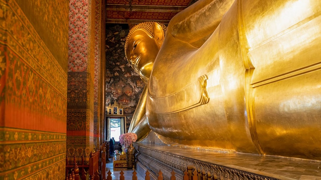 Reclining Buddha statue at Wat Pho, Bangkok, part of guided tour with mango dessert.