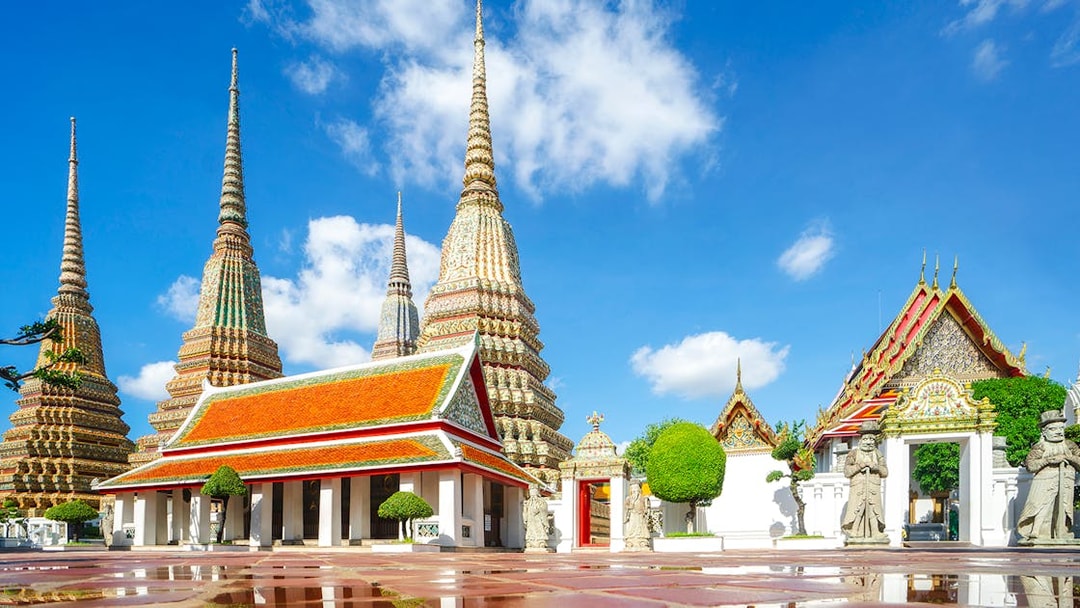 Wat Pho temple complex with ornate spires and traditional architecture in Bangkok.