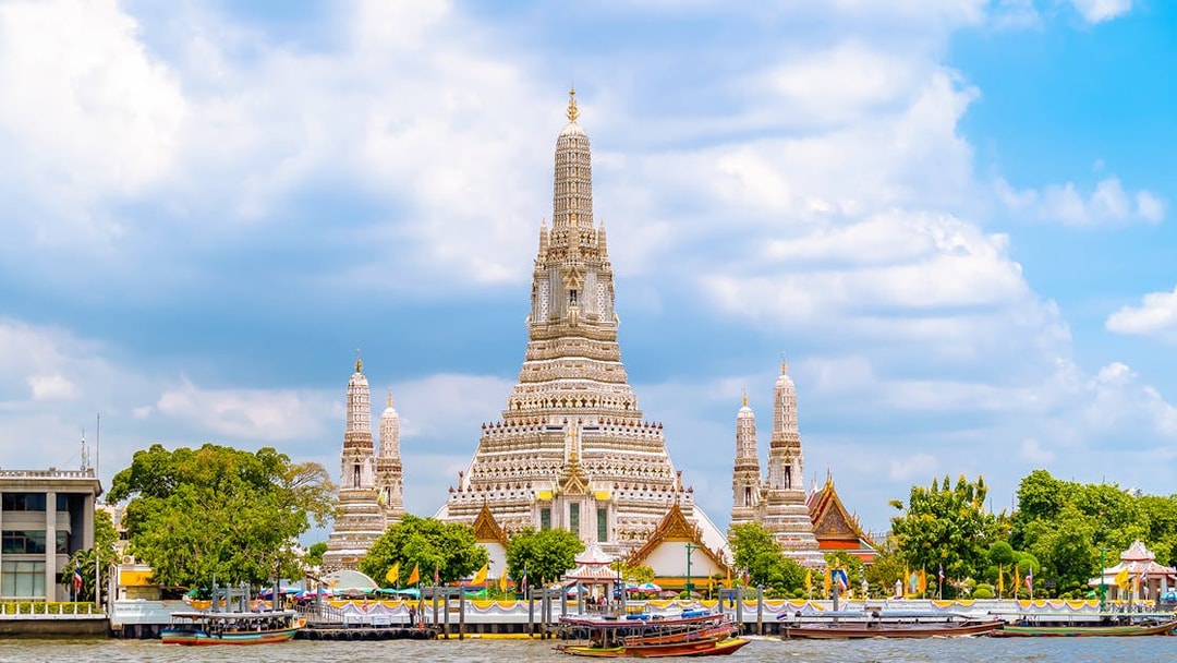 Wat Arun temple by the Chao Phraya River in Bangkok, Thailand.