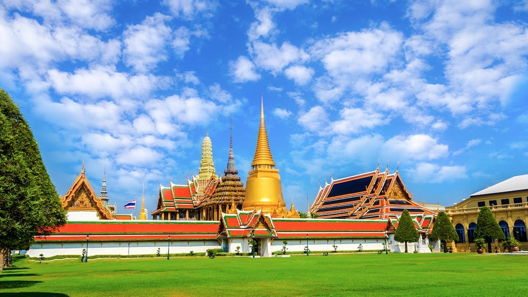 Wat Phra Kaew and Grand Palace complex in Bangkok with blue sky.