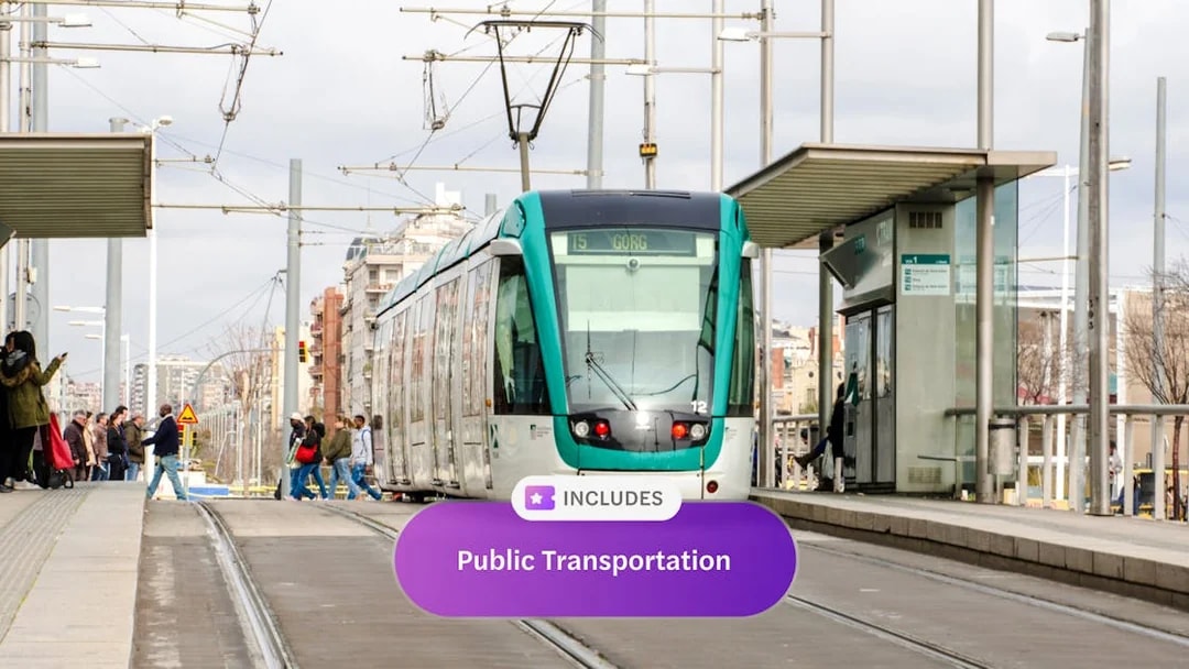 Tram at a station in Barcelona with passengers boarding.