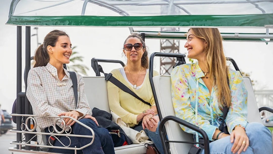 Tourists enjoying a tuk tuk ride in Barcelona.