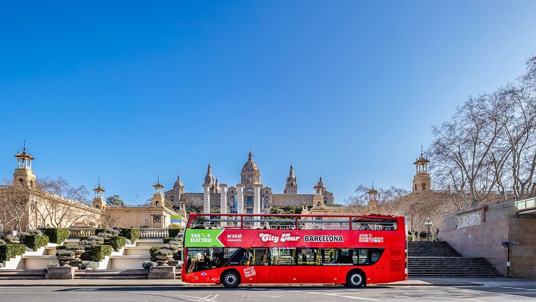 Red double-decker bus in front of the National Palace, Barcelona.