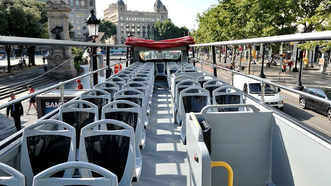 Open-top bus seats on Barcelona City Tour route.