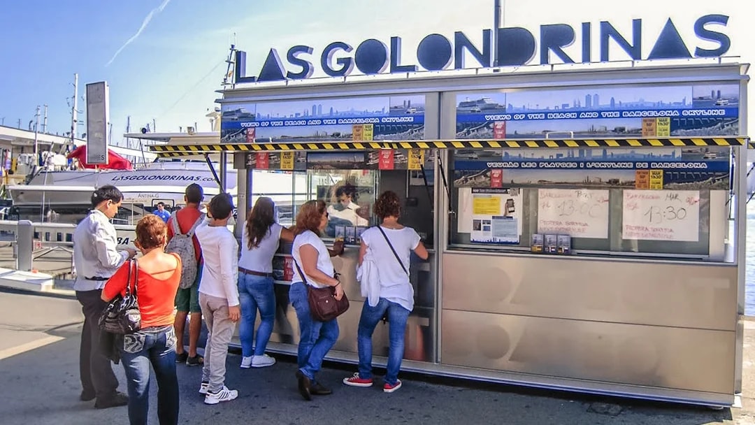 Visitors at Las Golondrinas ticket booth in Barcelona port.