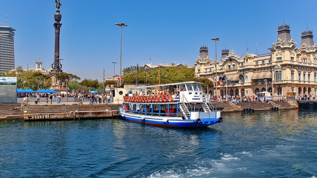 Las Golondrinas boat at Barcelona port with Columbus Monument in the background.