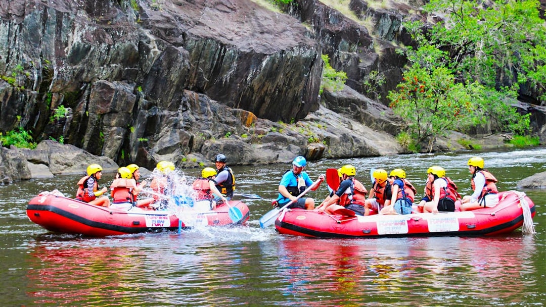 Rafters navigating Barron River rapids in Cairns, Australia, during half-day tour.