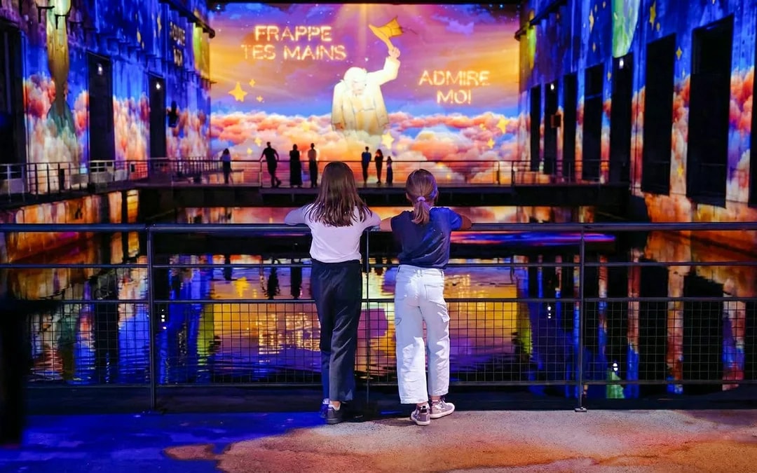 Children watching "The Little Prince" light show at Bassins des Lumières, Bordeaux.