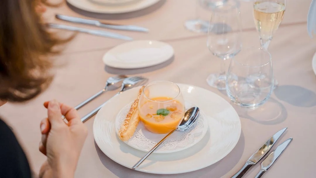 Elegant dining setup with soup and breadstick on Bateaux Mouches cruise.