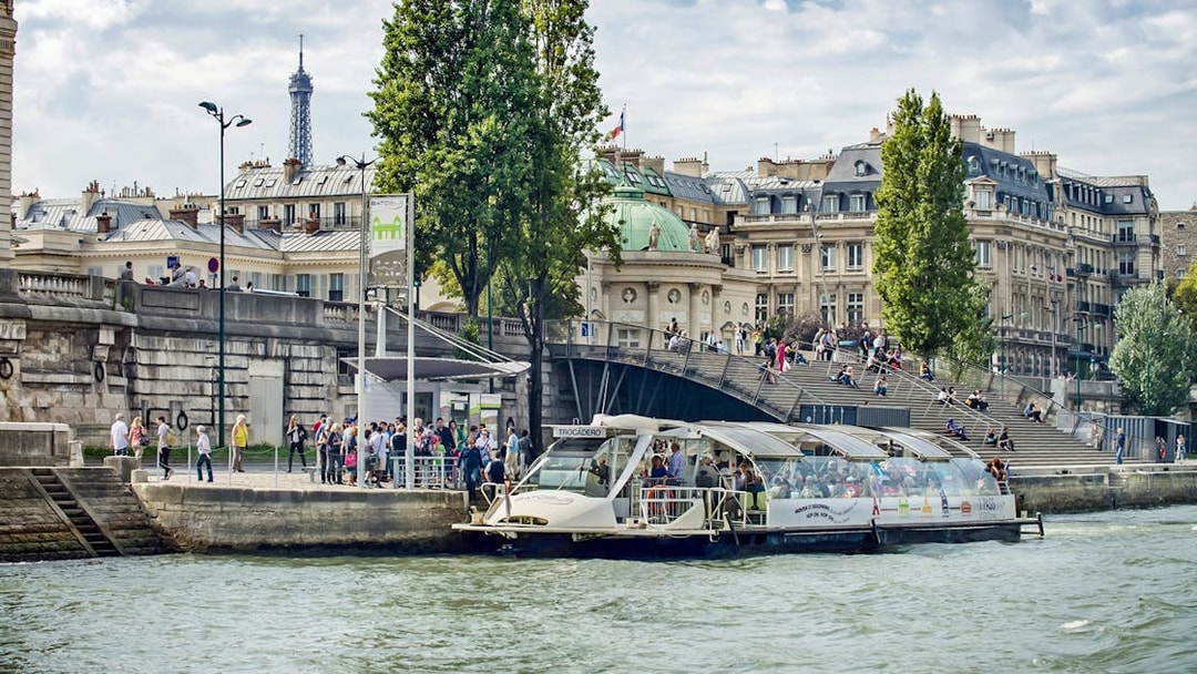 Batobus docked on the Seine River with Eiffel Tower in the background, Paris.