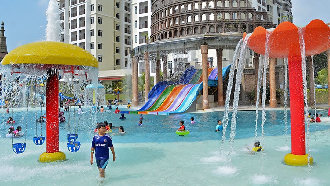 Children playing in the pool with colorful slides at Bayou Lagoon Water Park.