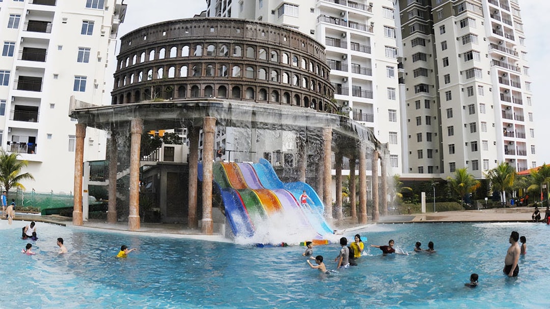Water slides and pool at Bayou Lagoon Water Park with people enjoying the attractions.