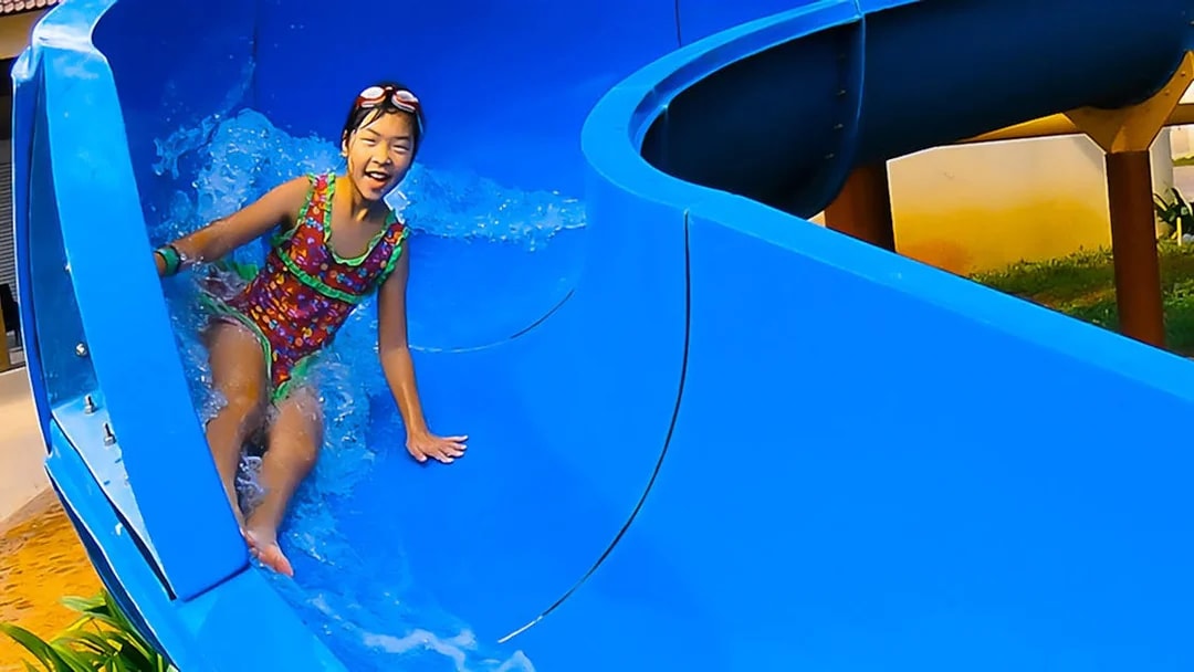 Child enjoying a water slide at Bayou Lagoon Water Park.