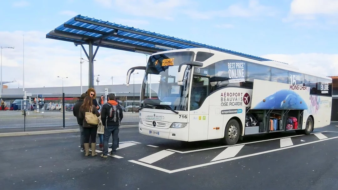 Passengers boarding bus at Paris Beauvais airport bus stop.