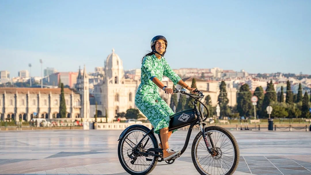 Person riding e-bike near Jerónimos Monastery, Lisbon, on Belém Riverside tour.