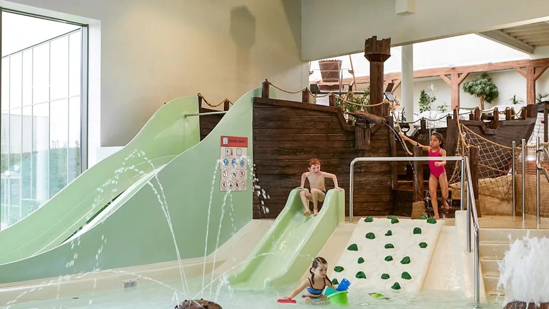 Children playing on slides and in water at Bellewaerde Aquapark, Ypres.