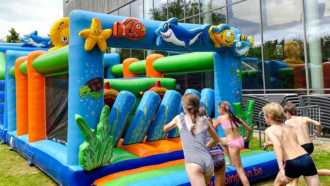 Children playing on an inflatable obstacle course at Bellewaerde Aquapark kids play area.