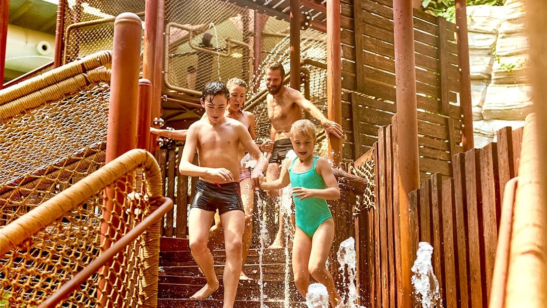 Tourists playing in the Aqua Fort section of Bellewaerde Aquapark.