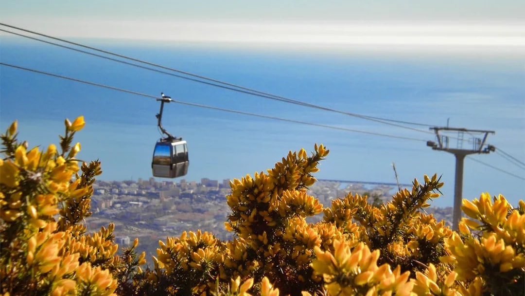 Cable car over Benalmadena with city and sea view in the background.