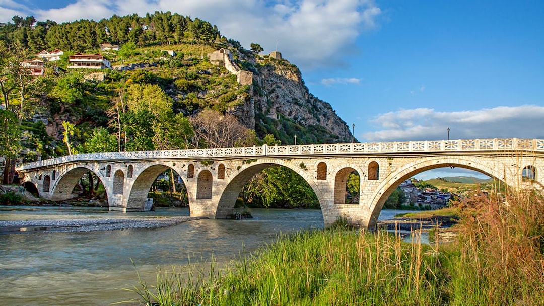 Historical arched bridge spanning the Osumi River in Berat, Albania.