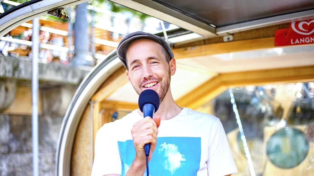Tour guide speaking into a microphone on a river cruise boat.