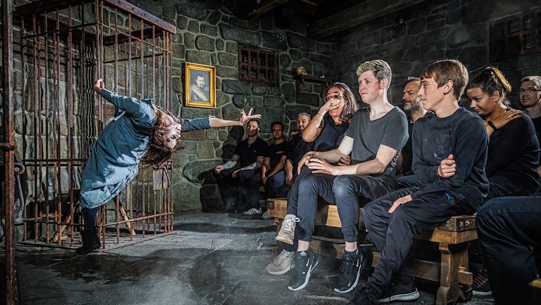 Witch performing in front of an audience inside the Berlin Dungeon.