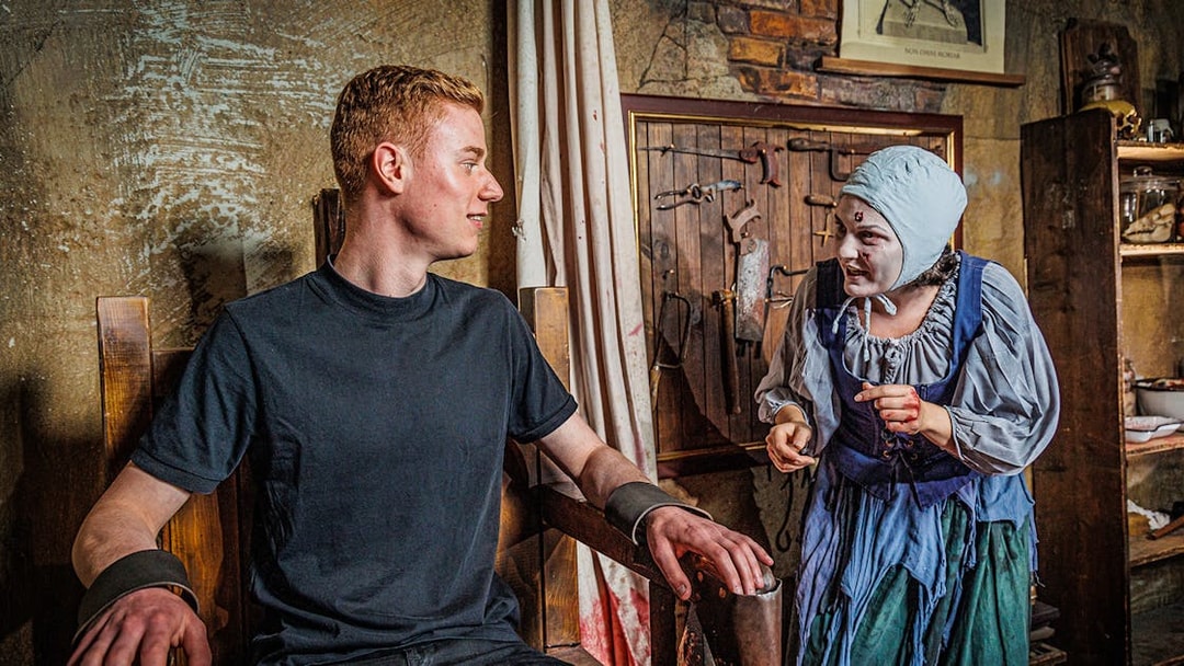 Visitor interacting with actor in historical costume at Berlin Dungeon.