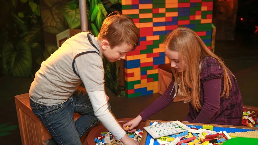 Children building with LEGO bricks at indoor playground, LEGOLAND Discovery Centre Berlin.