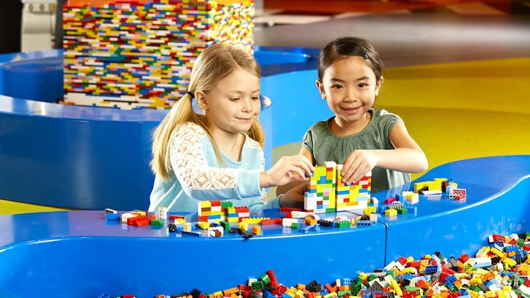 Children building with LEGO bricks at indoor playground, LEGOLAND Discovery Centre Berlin.