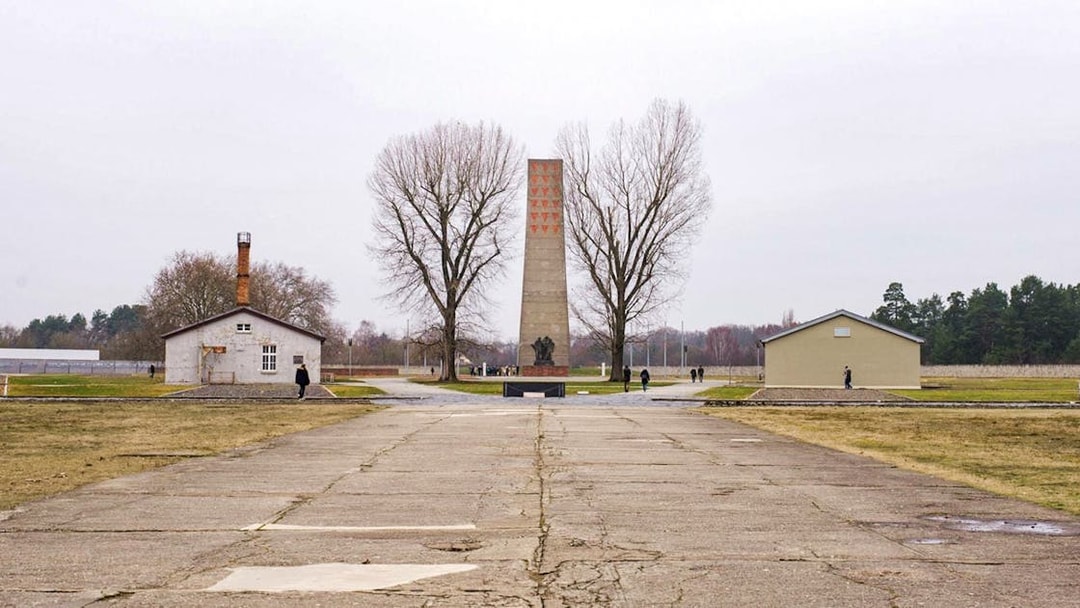 Sachsenhausen Concentration Camp memorial with central obelisk and surrounding buildings.