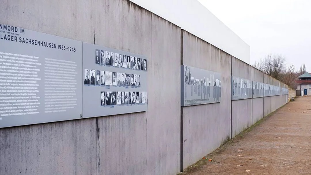 Memorial wall with historical photos and text at Sachsenhausen Concentration Camp.