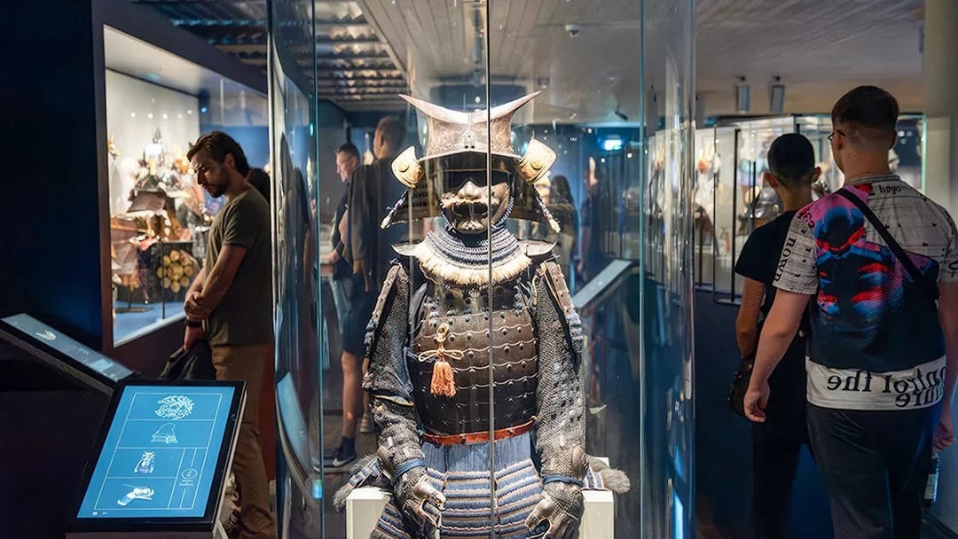 Samurai armor display at the Samurai Museum with visitors exploring exhibits.