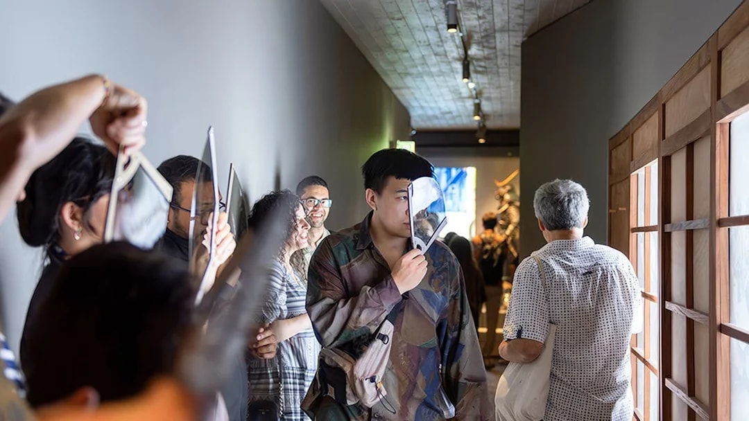 Visitors exploring exhibits at the Samurai Museum, engaging with interactive displays.