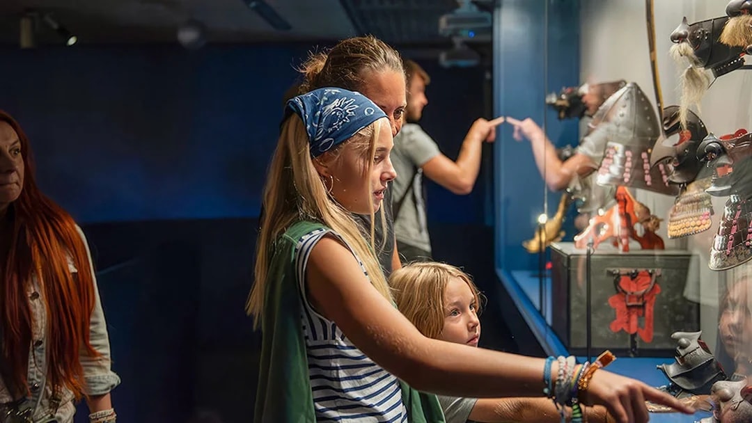 Visitors exploring samurai armor display at Berlin's Samurai Museum.