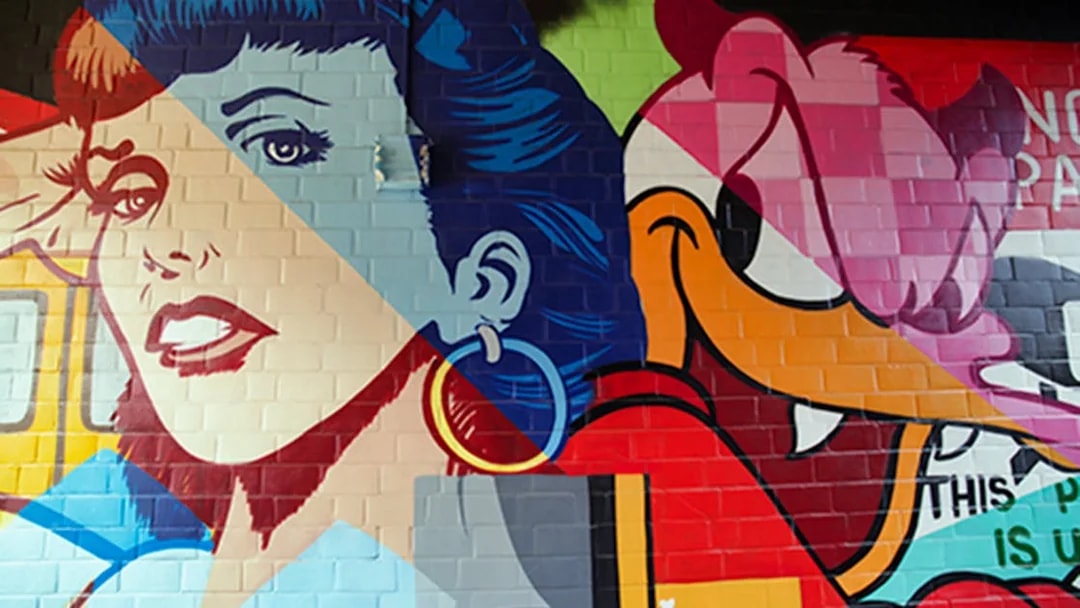Berlin street art mural featuring colorful pop art characters.