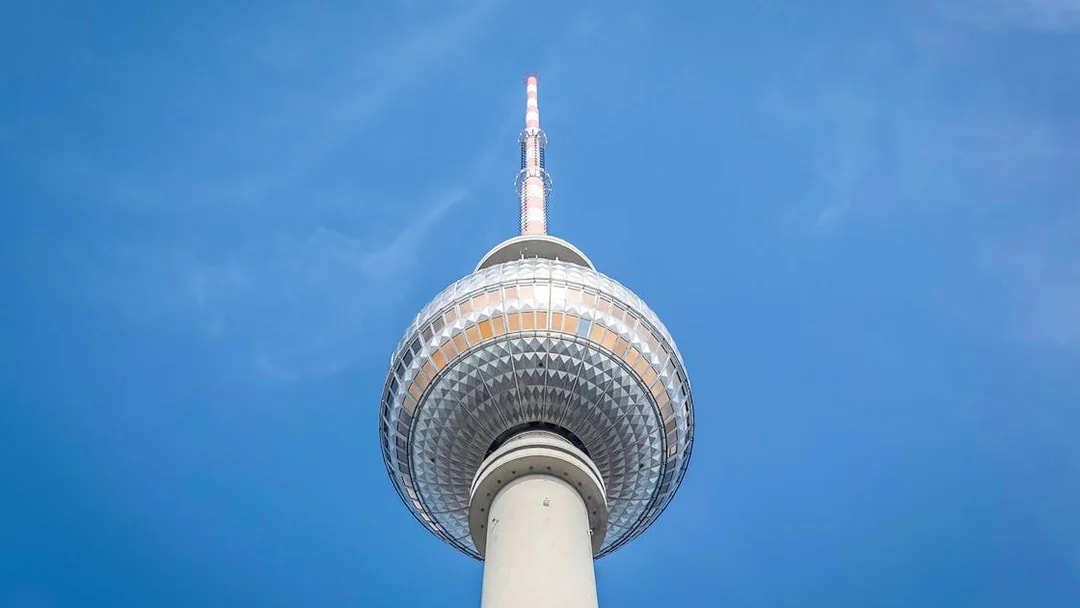 Berlin TV Tower closeup against blue sky.