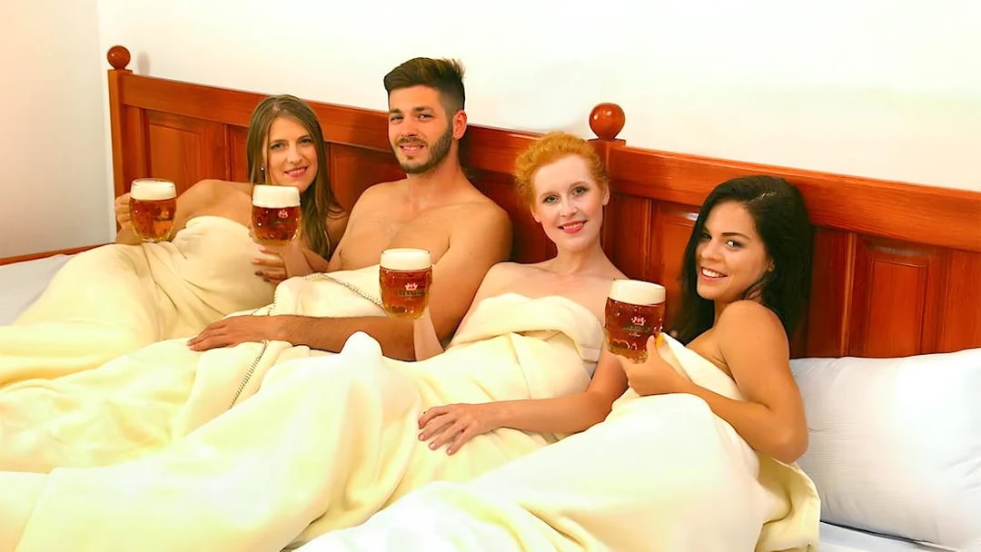Guests enjoying beer on a heated bed at Bernard Beer Spa.