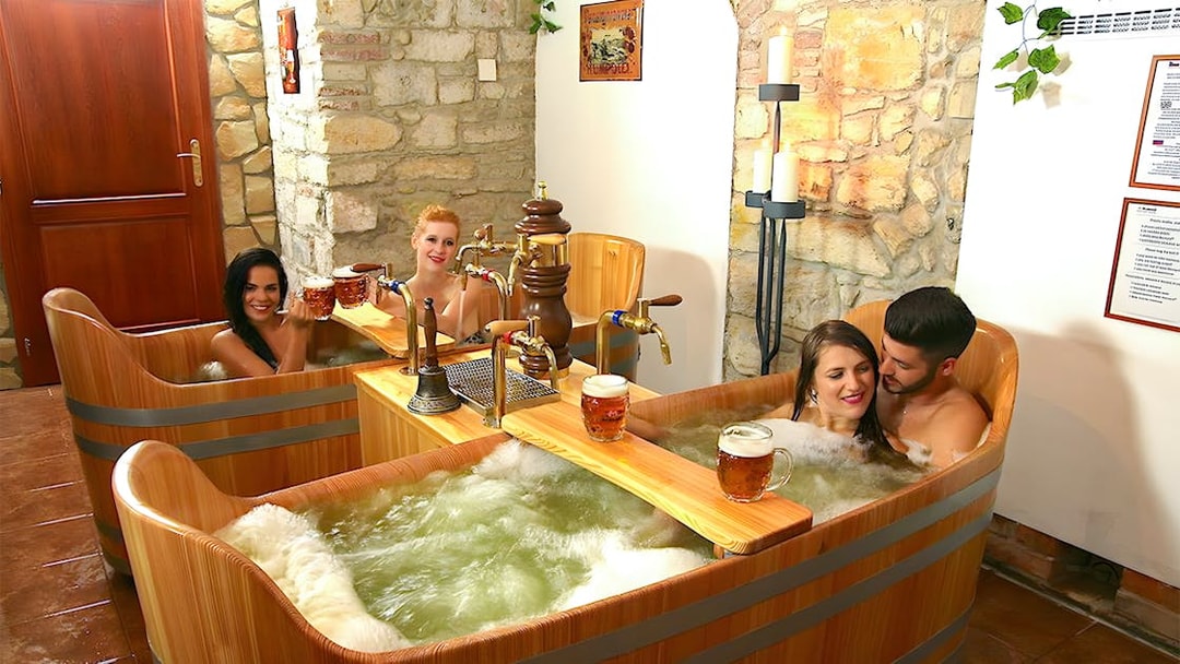 Couples enjoying a beer bath at Bernard Beer Spa.