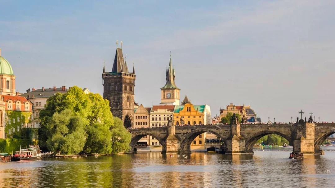 Charles Bridge over Vltava River with Prague's Old Town in the background.