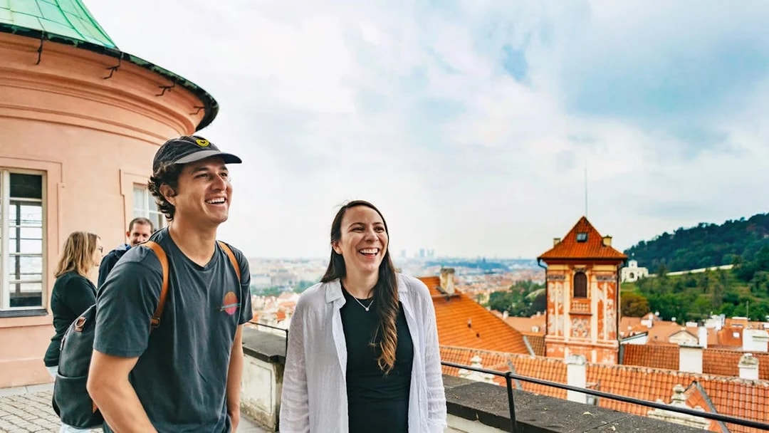 Tourists enjoying a view of Prague's historic architecture during a city tour.