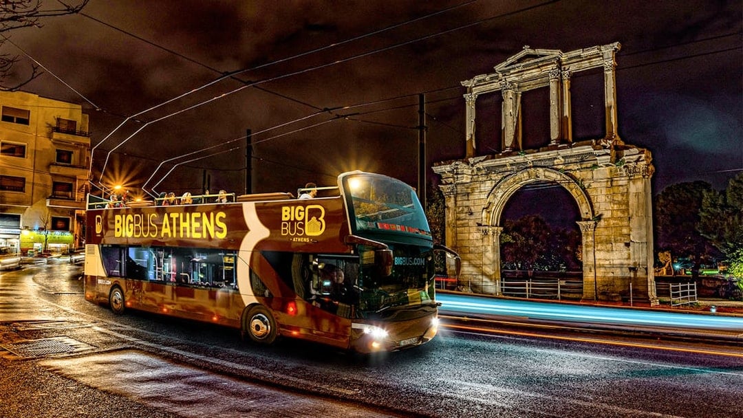 Big Bus Athens night tour passing Hadrian's Arch.
