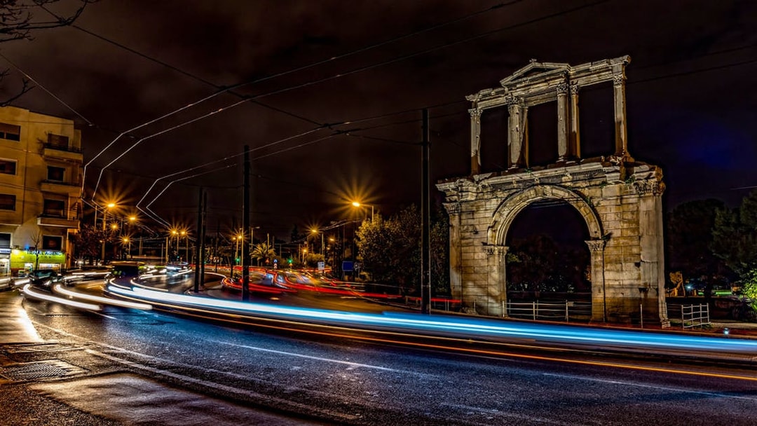 Hadrian's Arch illuminated at night during Athens bus tour.