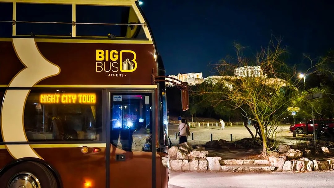 Big Bus Athens night tour with Acropolis view in the background.